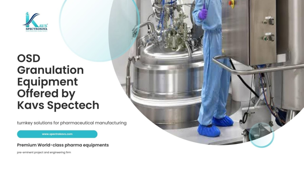 a man in blue overalls standing in a factory